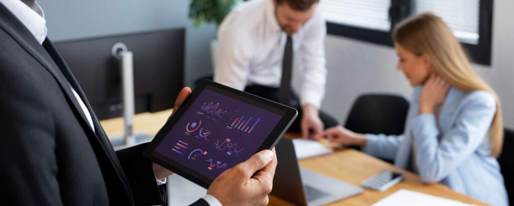 Executive analyzing financial data on a tablet with graphics generated by artificial intelligence and automation in fintech.