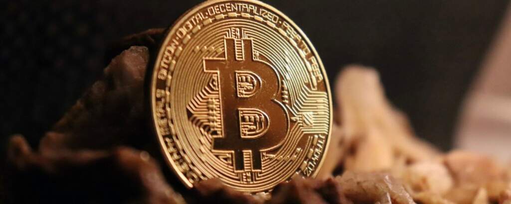 Close-up of a physical bitcoin coin, representing the growth and use of cryptocurrencies in the Web 3 and blockchain ecosystem.